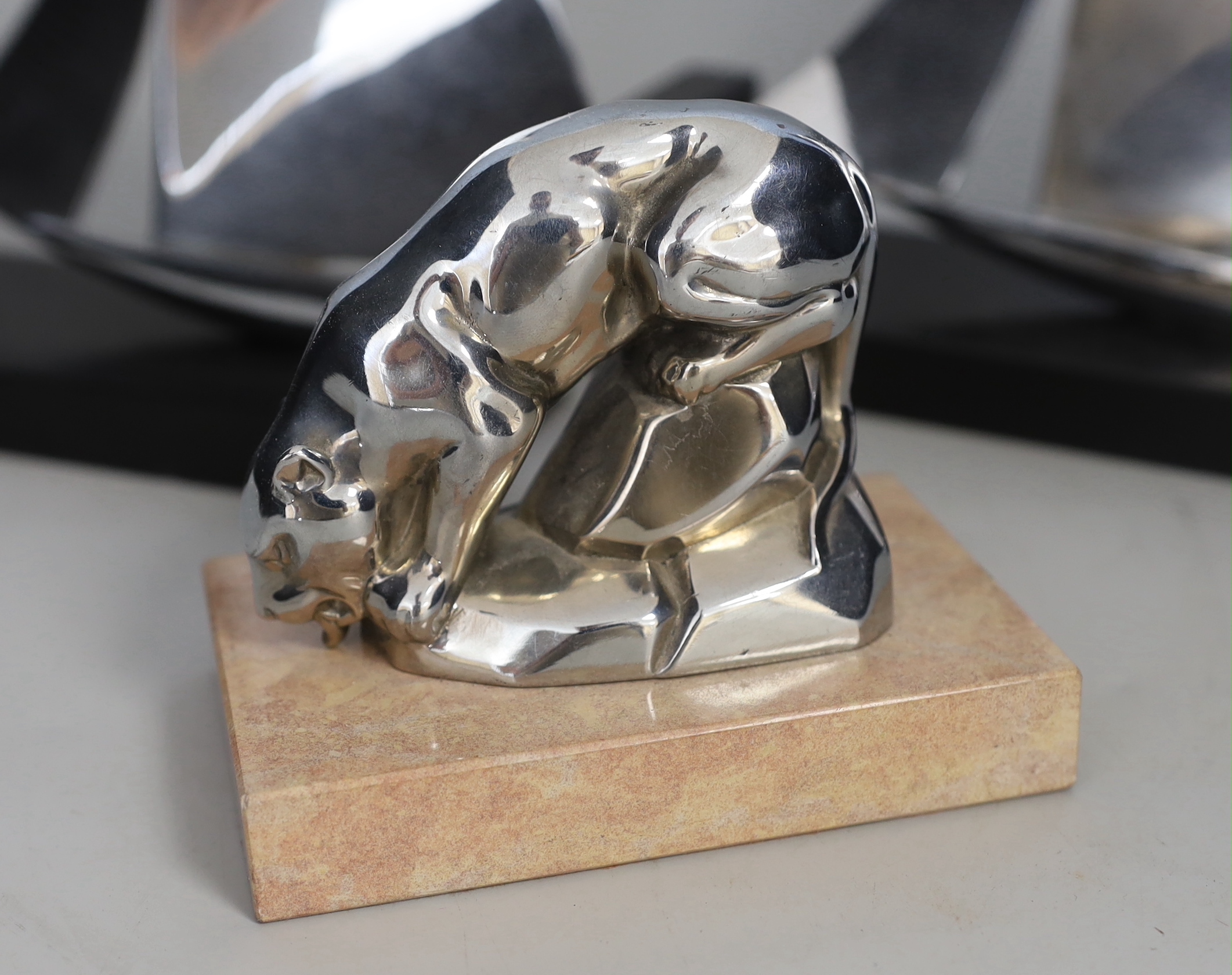 An Art Deco chrome model of a lioness drinking, possibly a car mascot and a pair of chrome yacht bookends, 20cm each wide